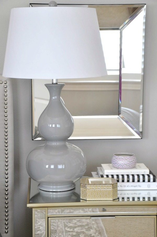 neutral master bedroom, gray lamp and mirror accents