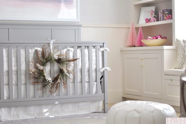 Pretty holiday wreath hung from crib in nursery.  | Honey We're Home