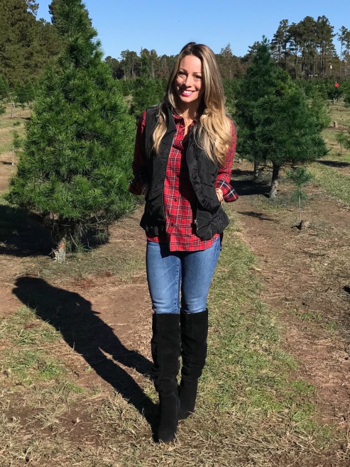 Red plaid shirt with jeans and black vest black boots